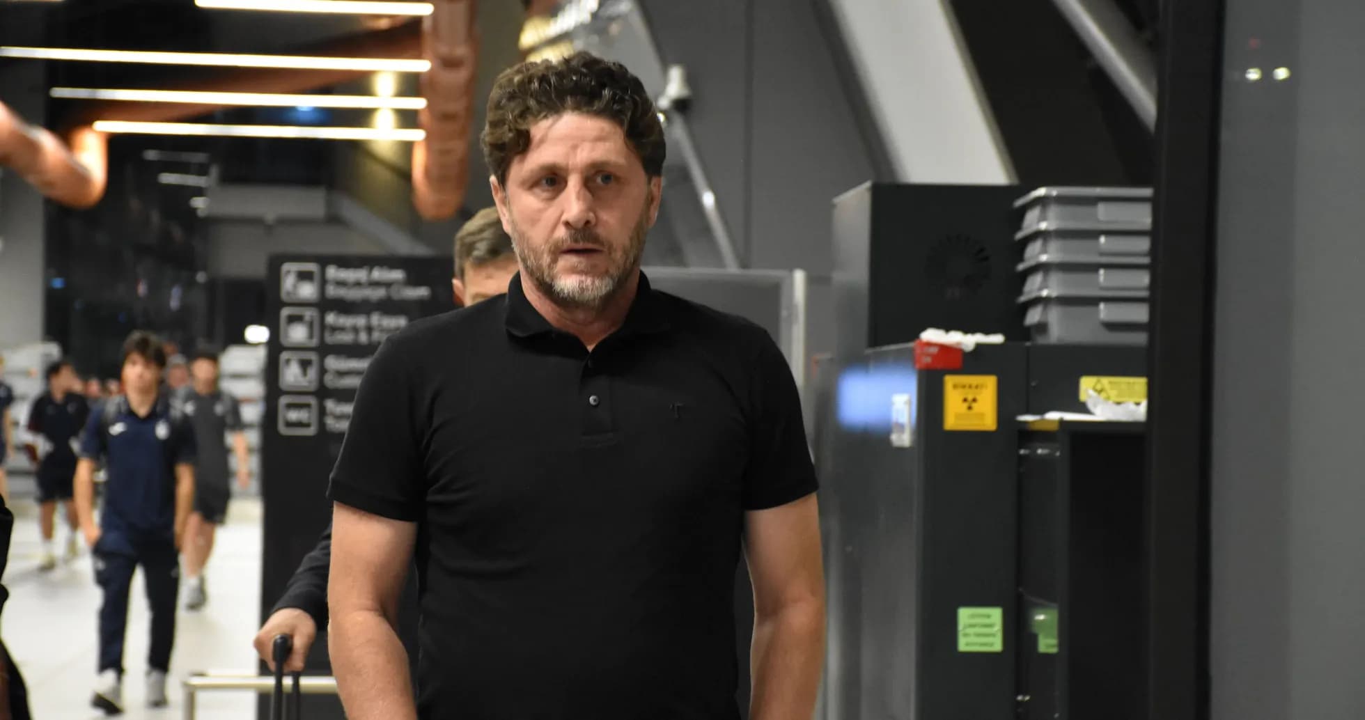 Man walking through an airport terminal
