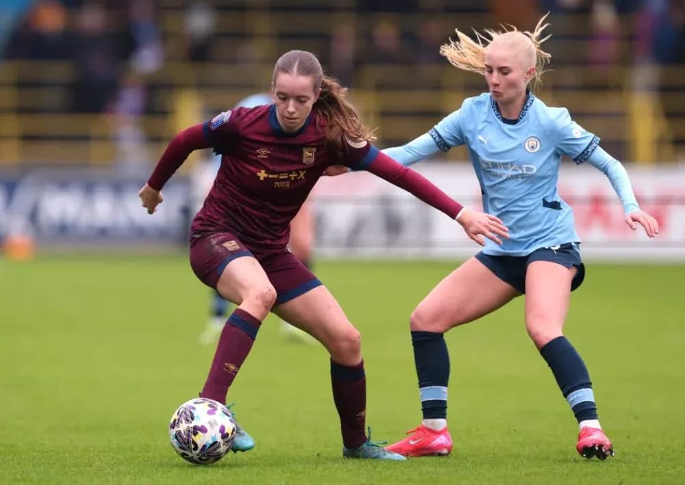 Two female players contesting the ball during match