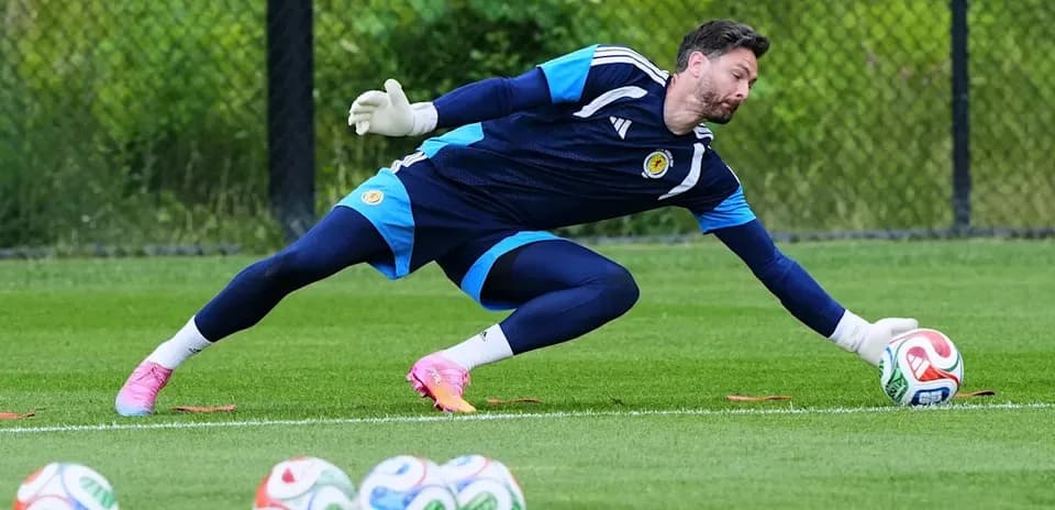 Goalkeeper diving to catch ball during training session