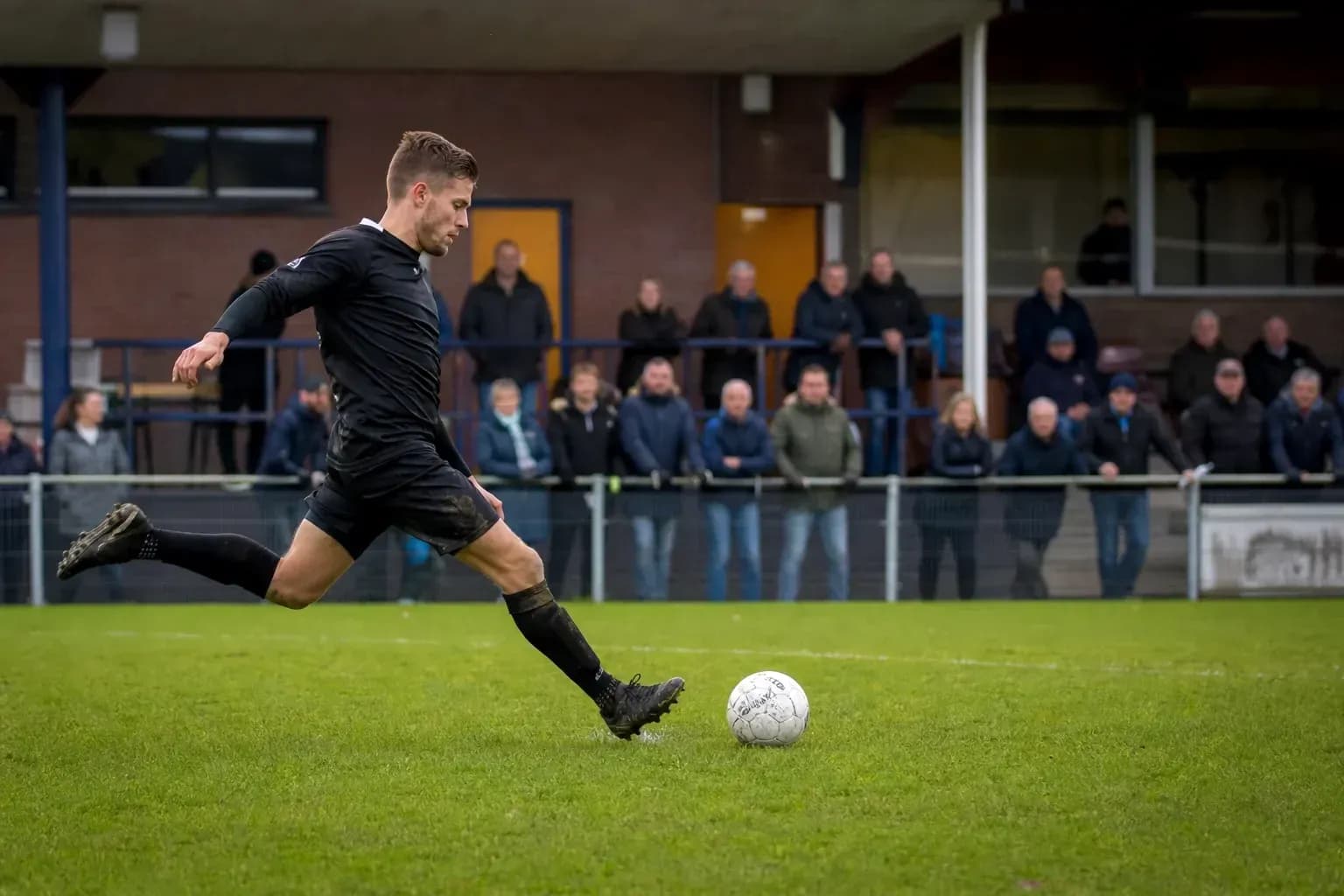 Player kicking a soccer ball during a match