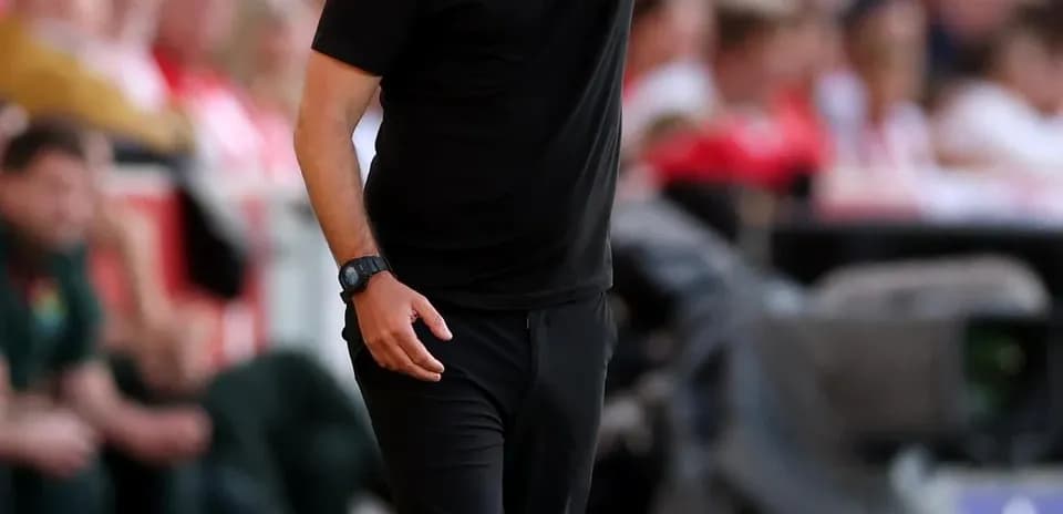 Coach directing players during a match on the sideline