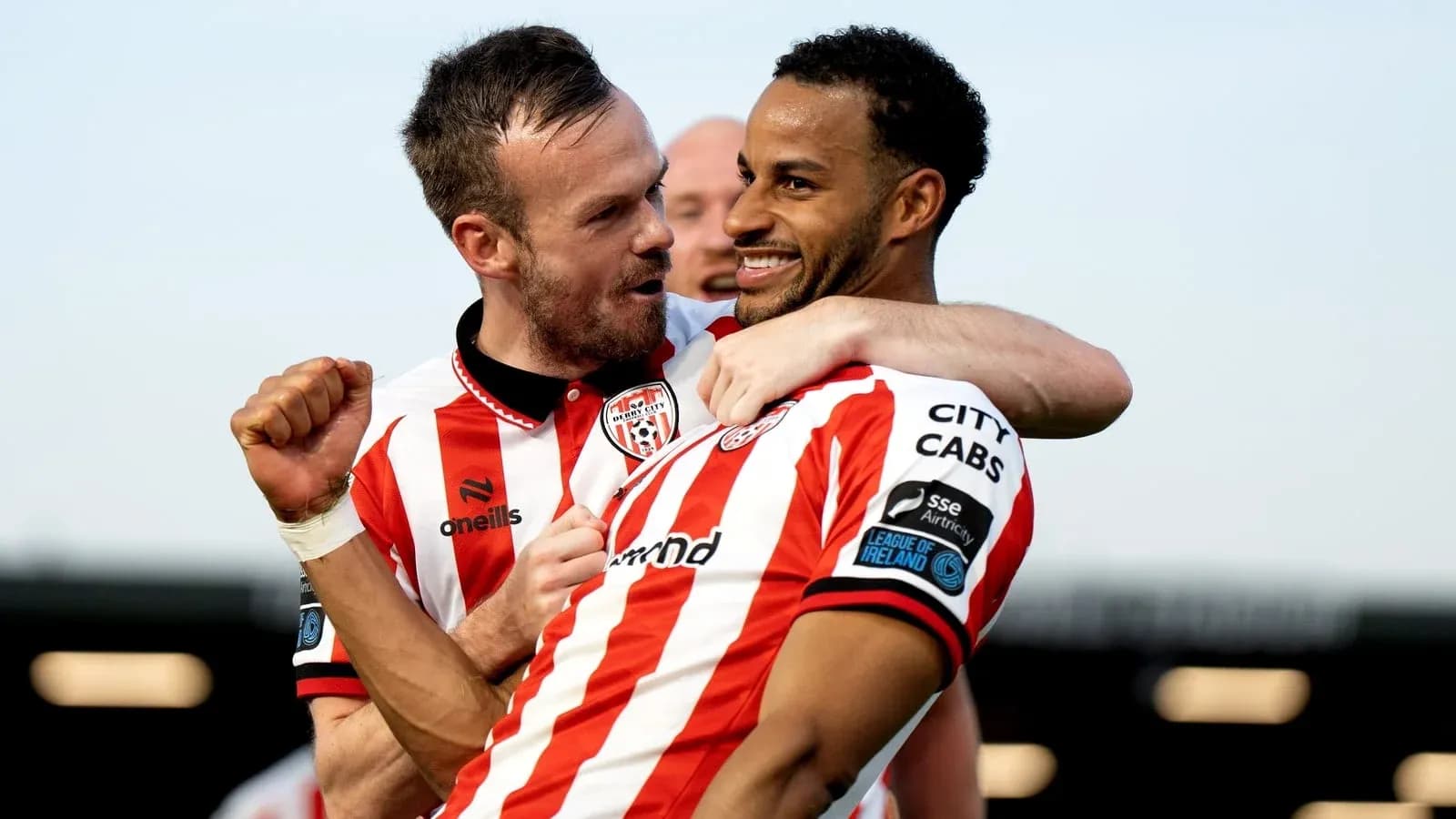 Two Derry City players celebrating a goal together Two Derry City players celebrating a goal together