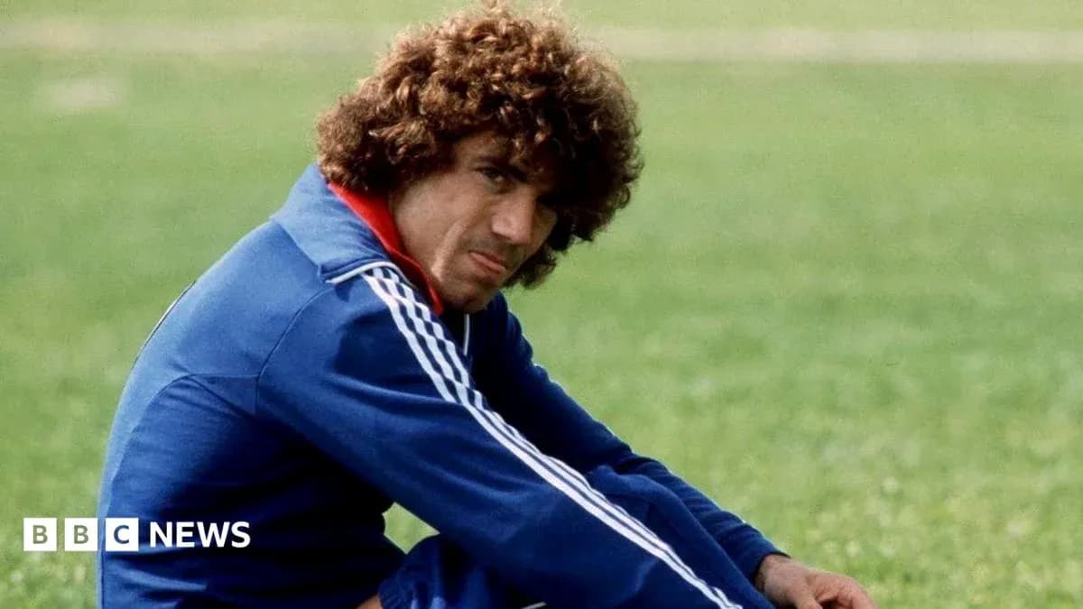 Player sitting on grass field in sports attire Player sitting on grass field in sports attire