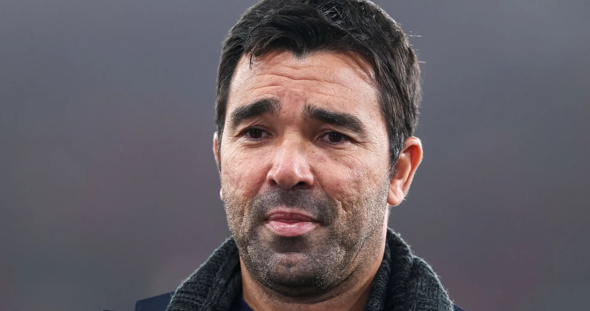 Man with short dark hair and a scarf Man with short dark hair and a scarf