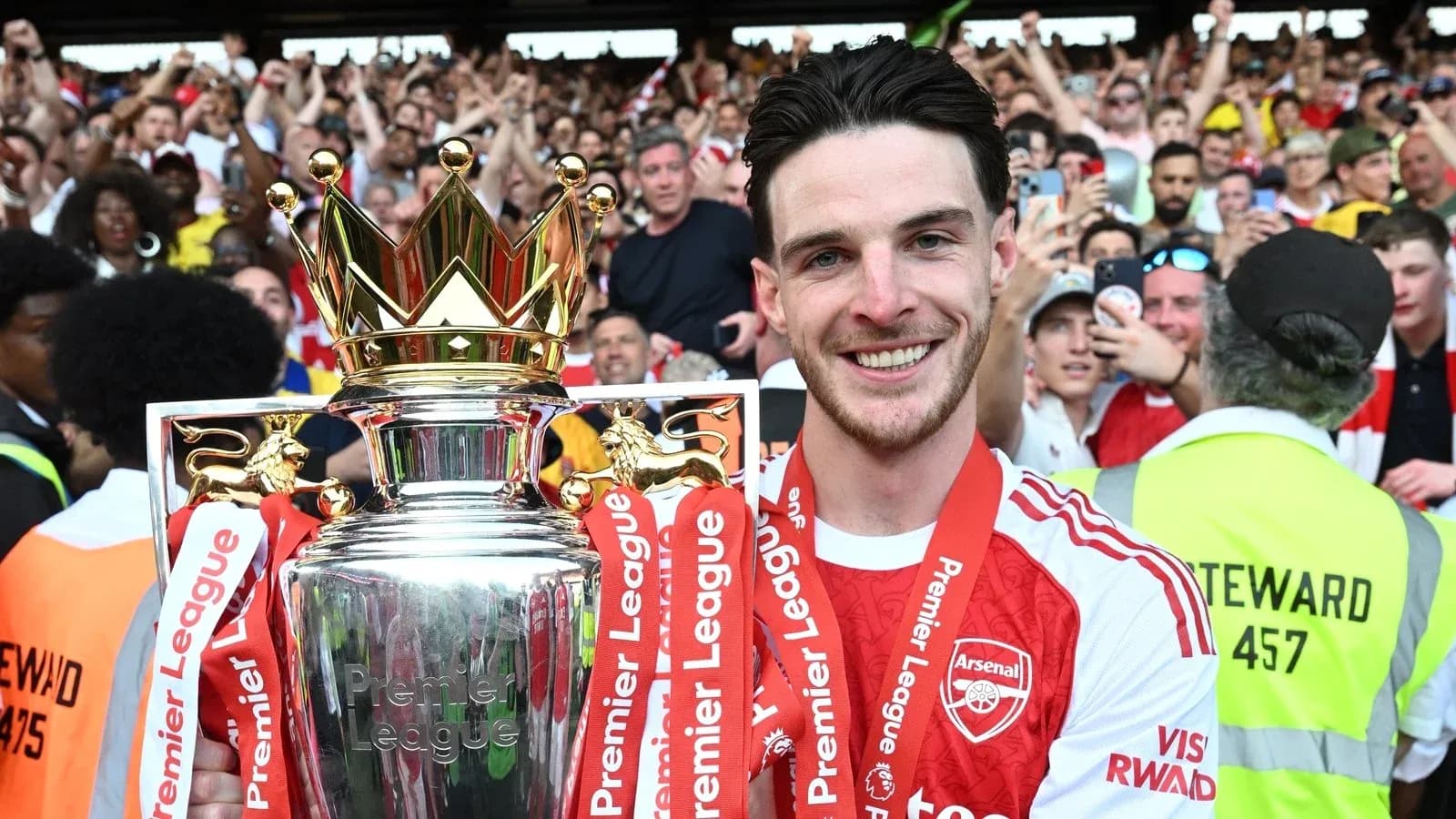 Player holding Premier League trophy in celebration Player holding Premier League trophy in celebration
