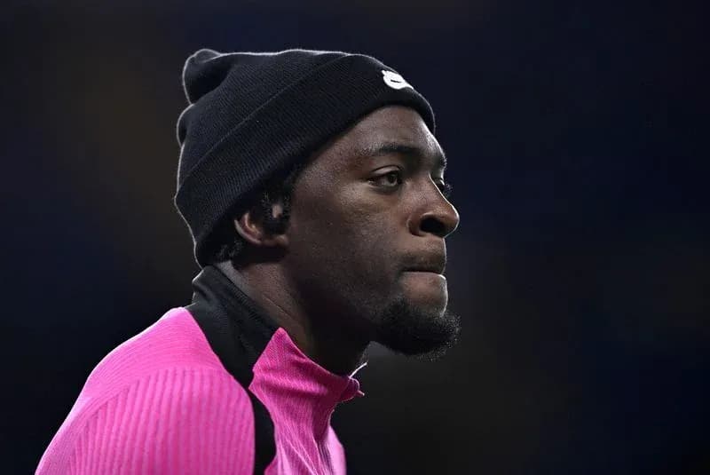 Player in pink training top and black beanie Player in pink training top and black beanie