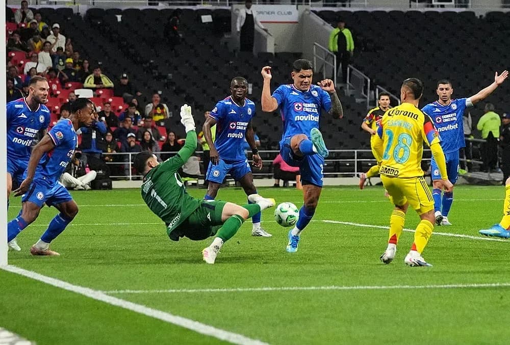 Cruz Azul player kicking the ball against America Cruz Azul player kicking the ball against America