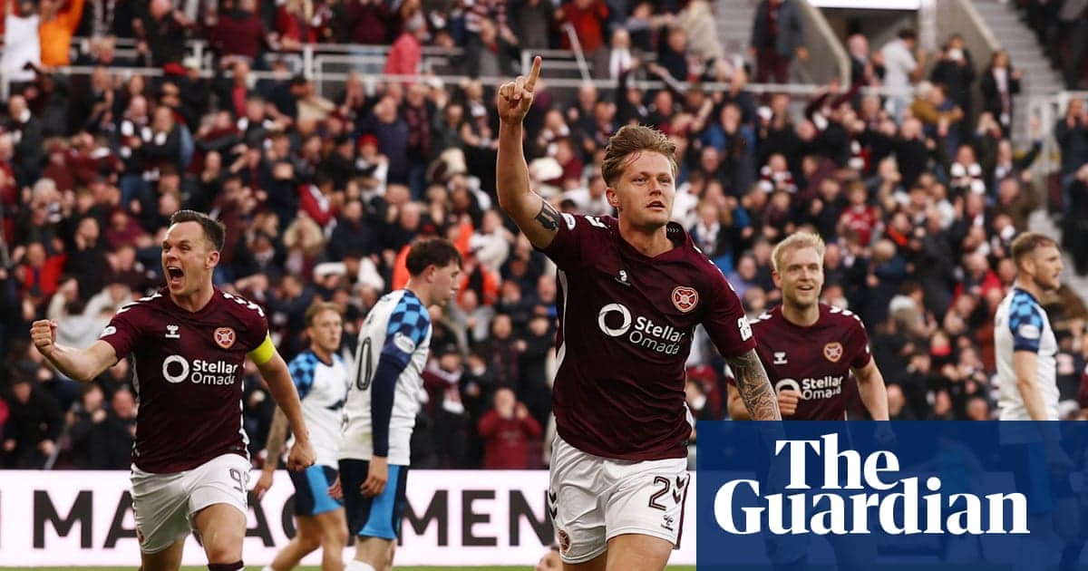 Hearts player celebrating a goal with fans cheering Hearts player celebrating a goal with fans cheering