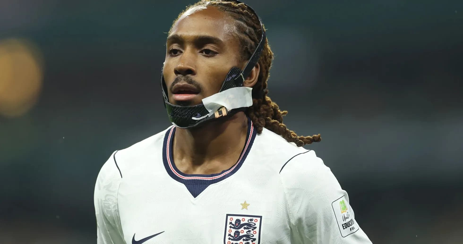 Player wearing mask during football match Player wearing mask during football match