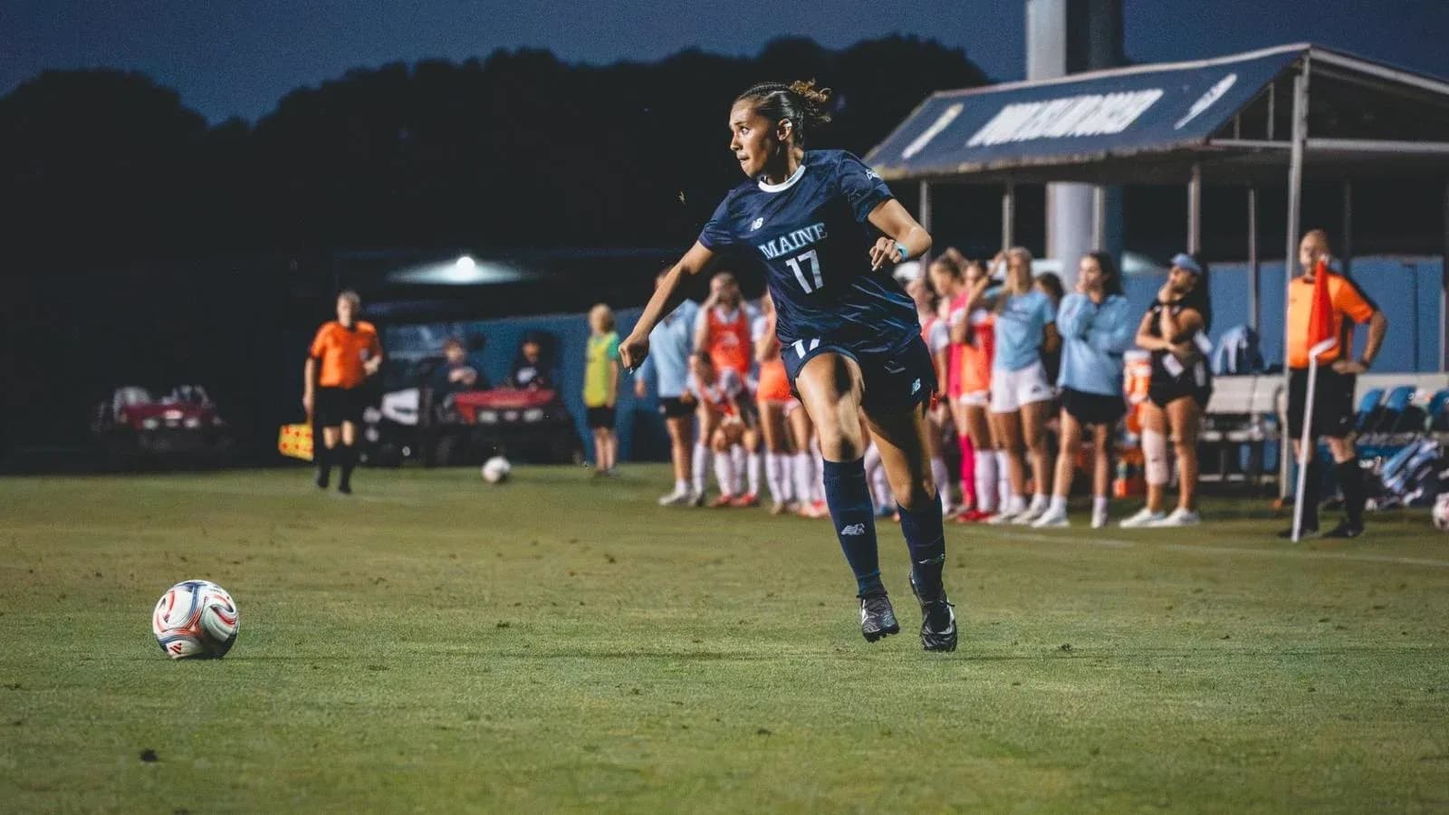 Player from Maine kicking ball during soccer match Player from Maine kicking ball during soccer match