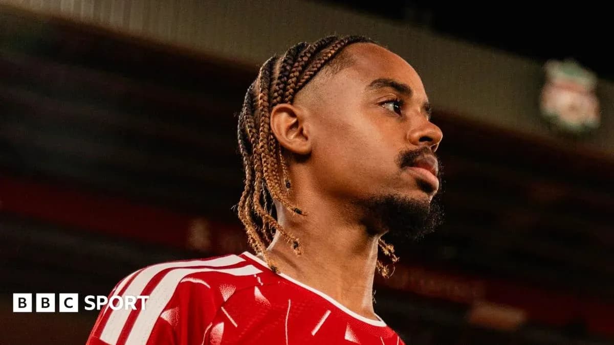 Player in red jersey looking away from camera Player in red jersey looking away from camera