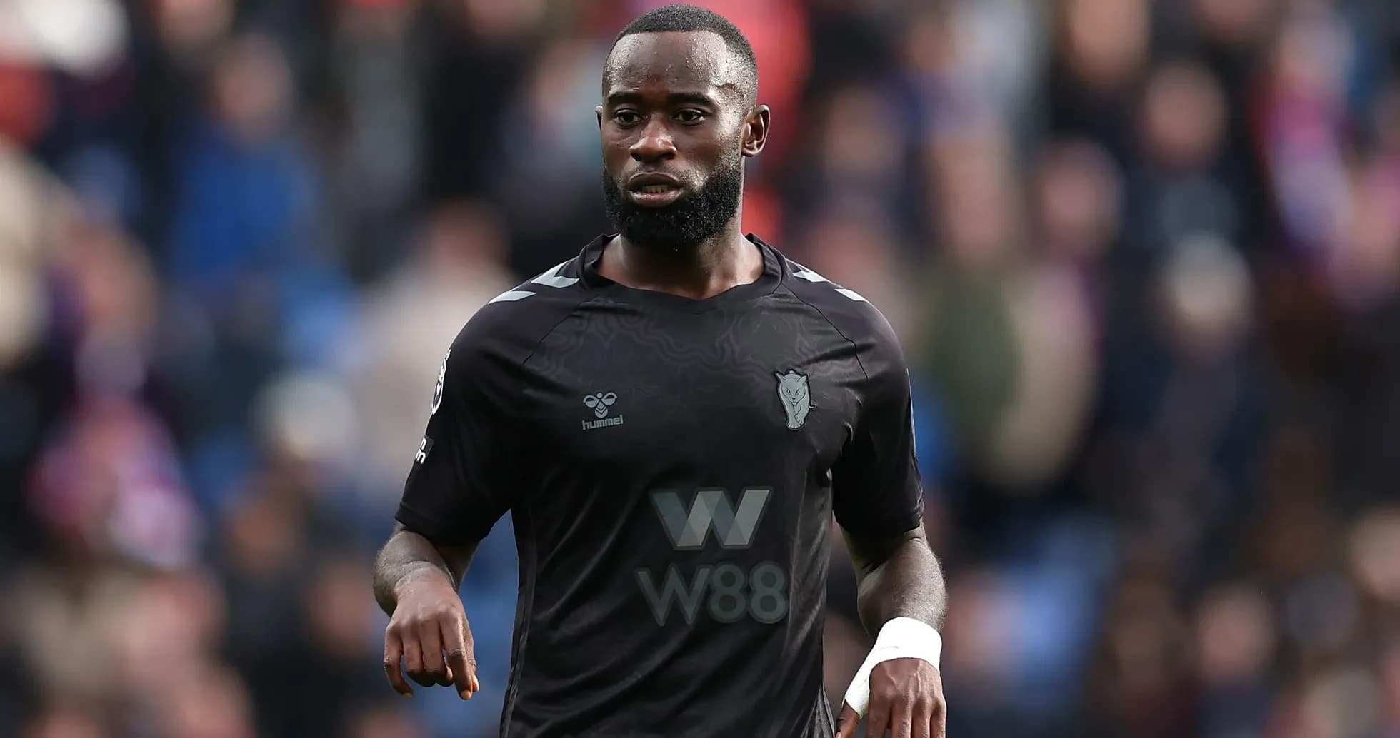 Player in black kit on the pitch during match Player in black kit on the pitch during match