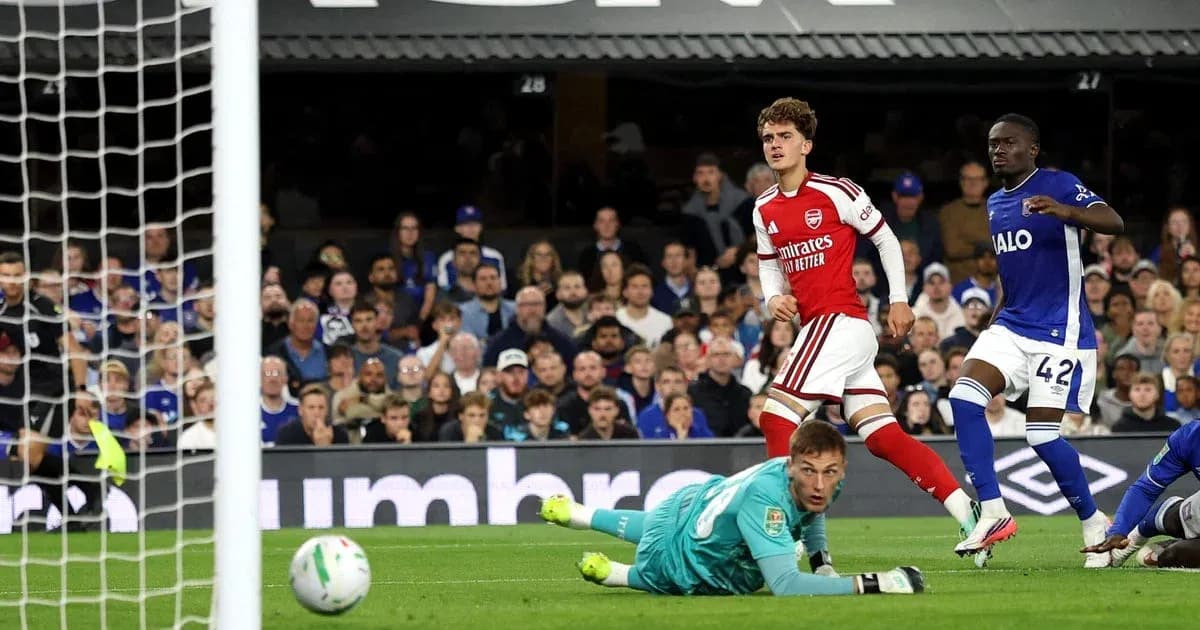 Arsenal player celebrates scoring against the goalkeeper Arsenal player celebrates scoring against the goalkeeper
