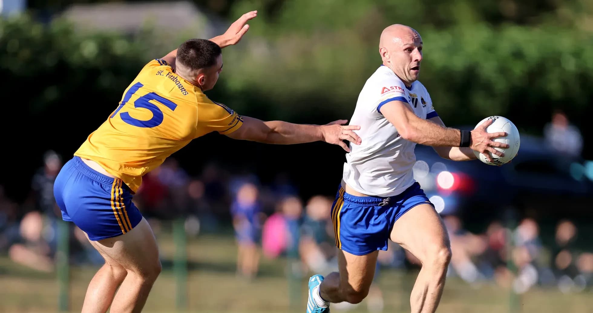 Player evading tackle while holding the ball Player evading tackle while holding the ball