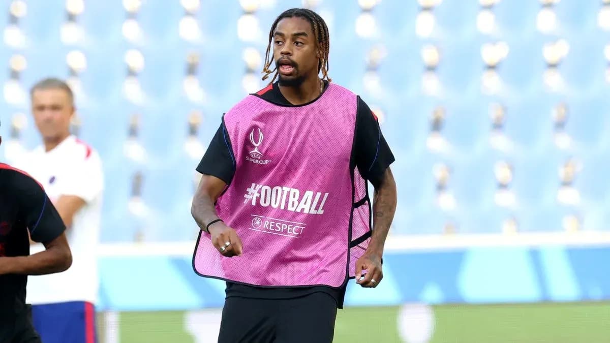 Player running during training session in pink vest Player running during training session in pink vest