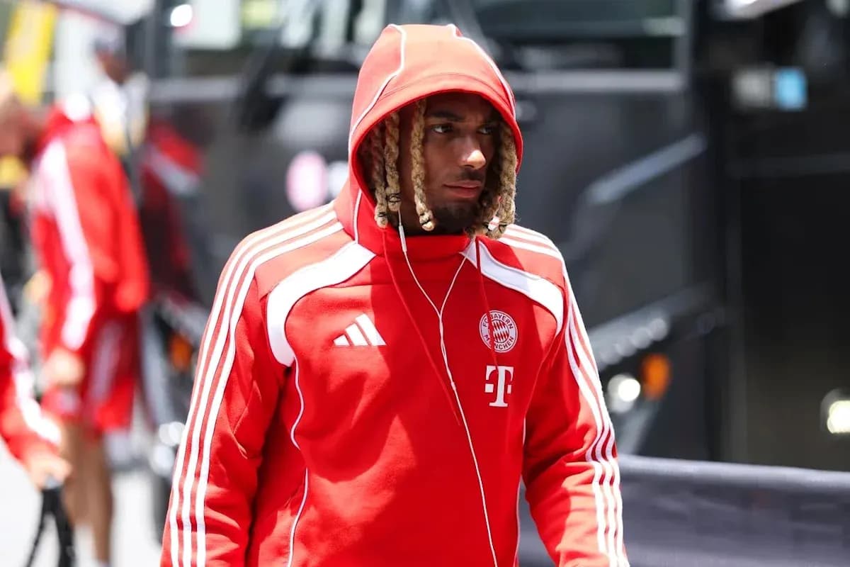 Player in red hoodie arriving at team bus Player in red hoodie arriving at team bus