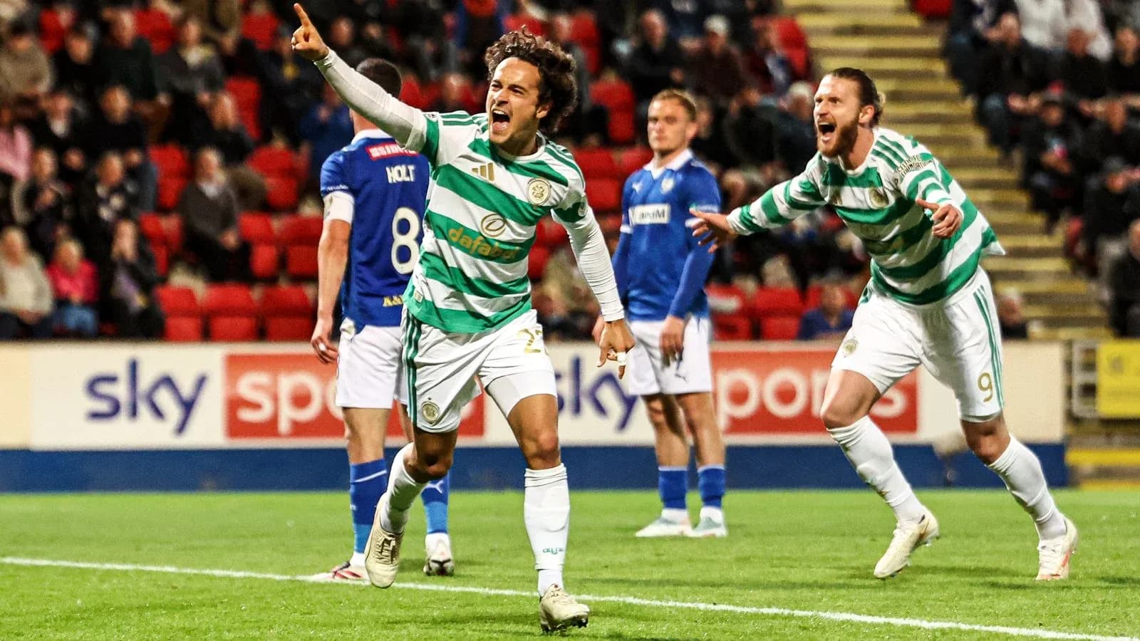 Celtic players celebrating a goal on the pitch Celtic players celebrating a goal on the pitch