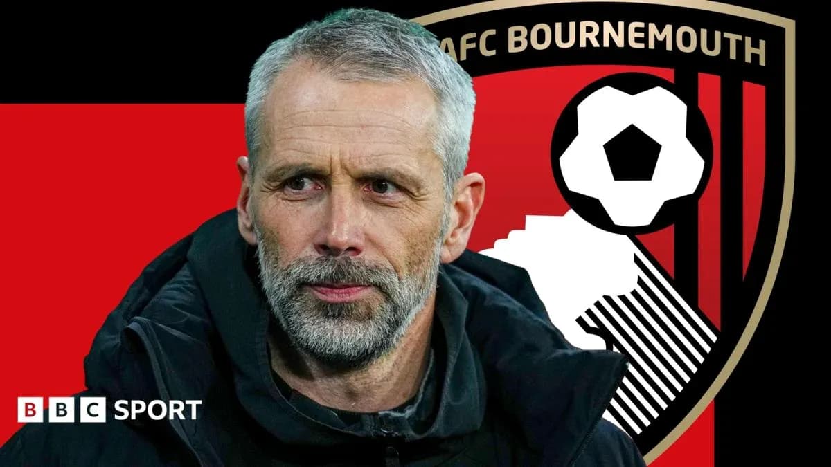 Coach in front of AFC Bournemouth club logo Coach in front of AFC Bournemouth club logo
