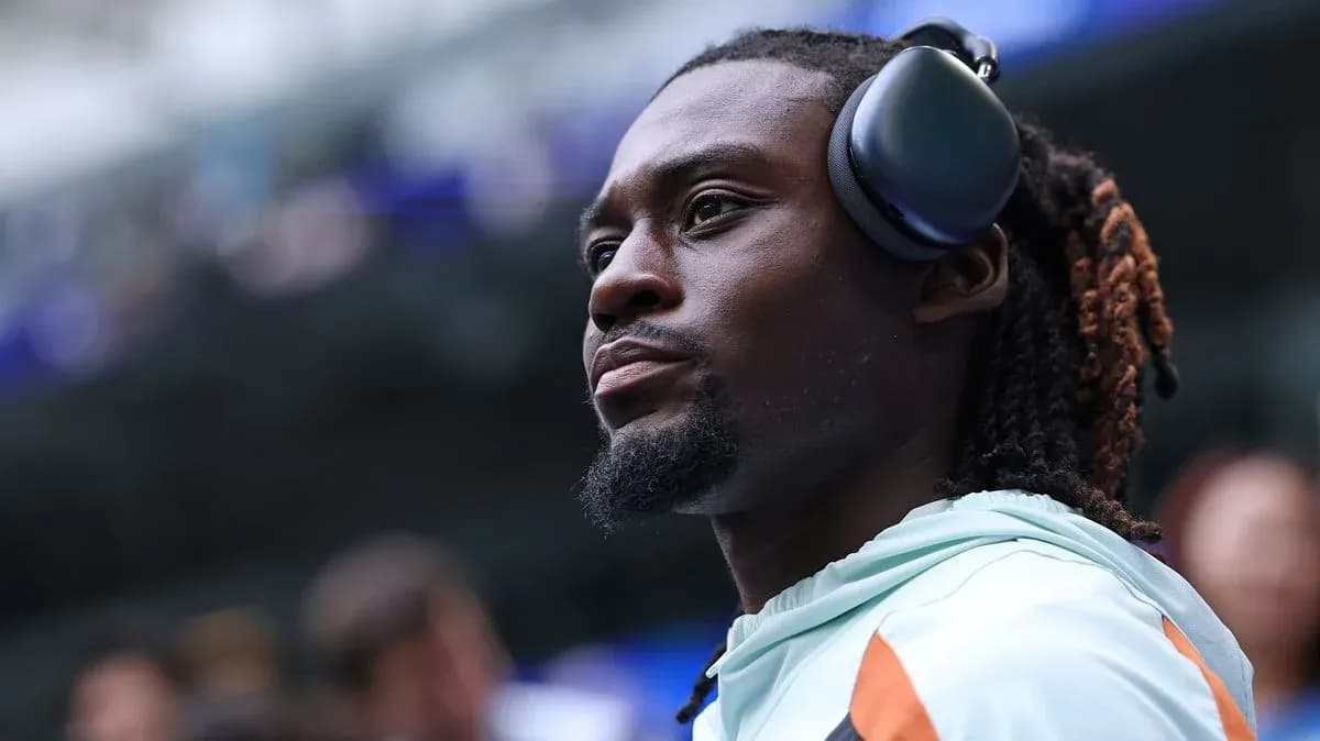 Player wearing headphones on sidelines before game Player wearing headphones on sidelines before game