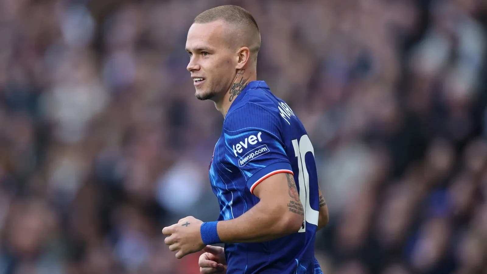 Player in blue jersey running on the field Player in blue jersey running on the field