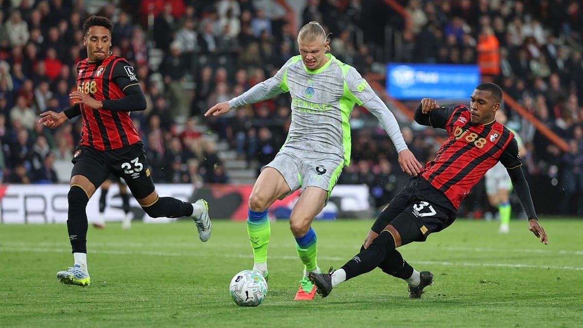 Bournemouth player tackling Manchester City striker Bournemouth player tackling Manchester City striker