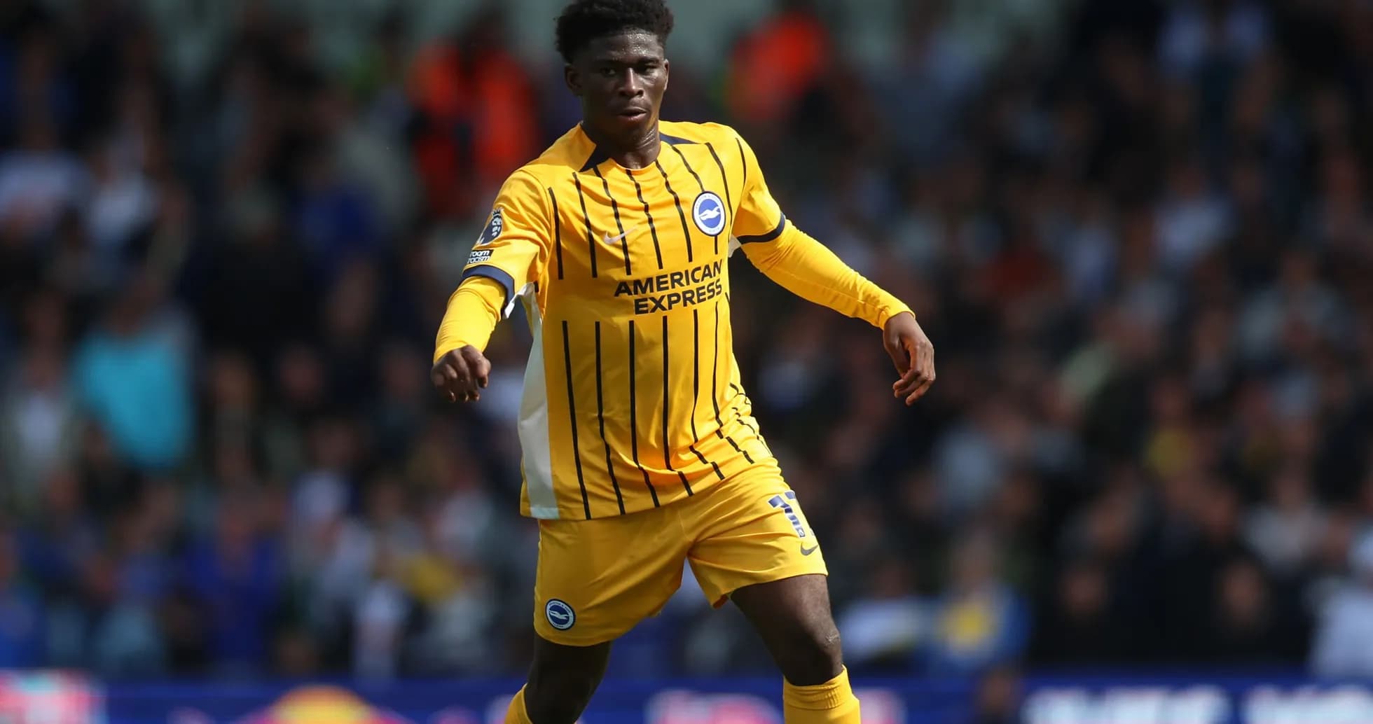 Player in yellow kit running during match Player in yellow kit running during match