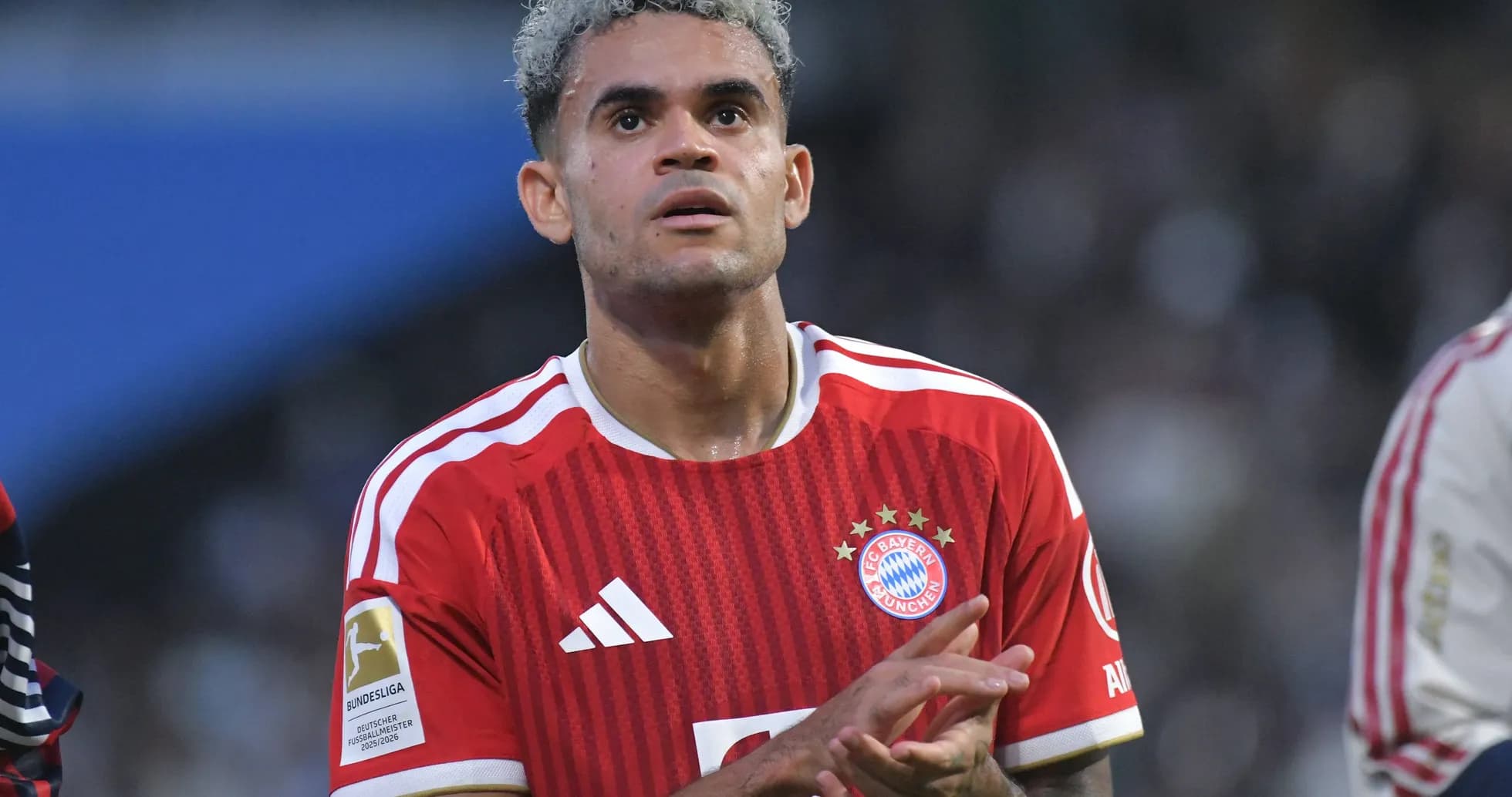 Player in Bayern Munich jersey clapping on the field Player in Bayern Munich jersey clapping on the field