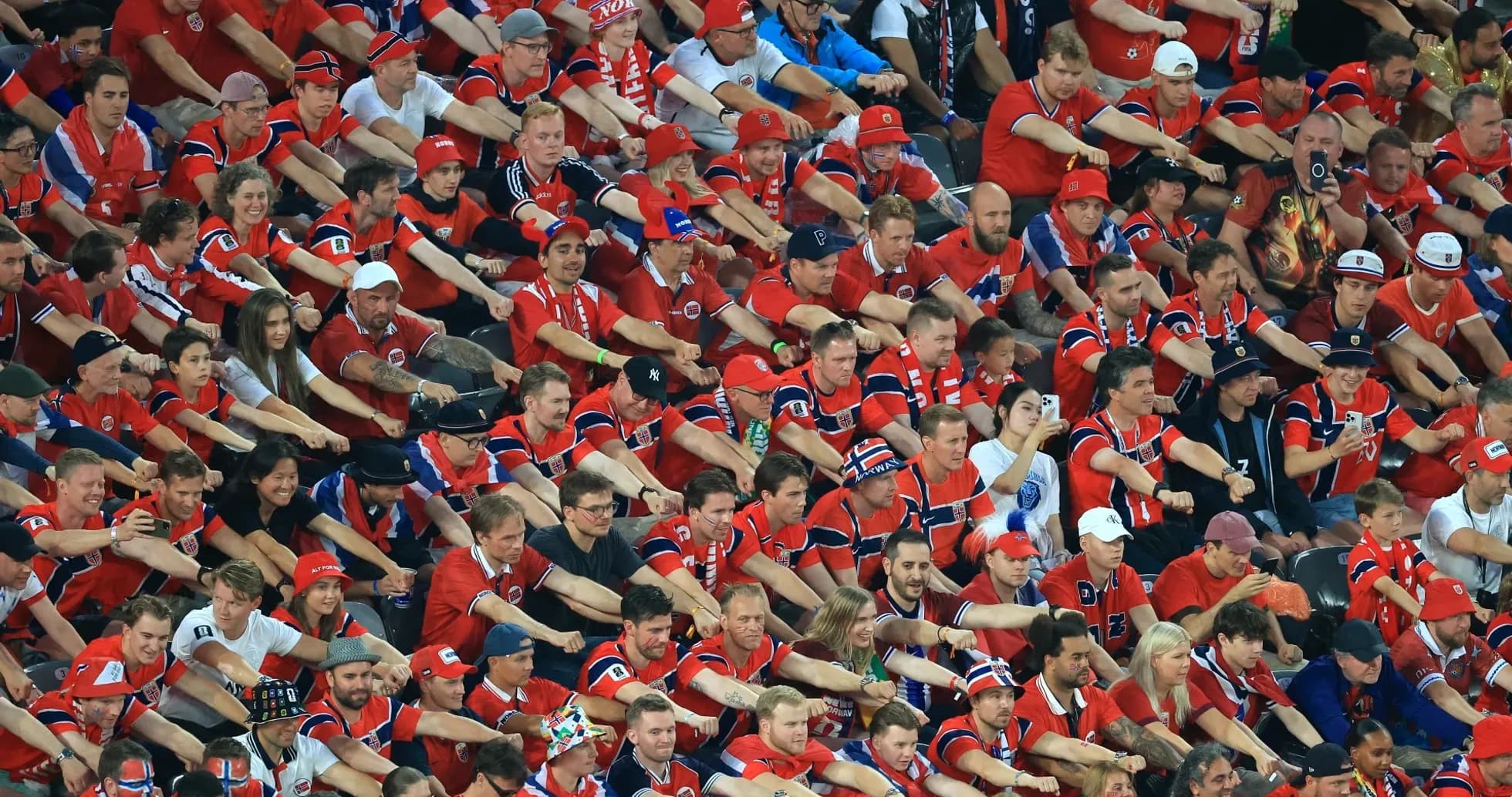Crowd of fans wearing red cheering at event Crowd of fans wearing red cheering at event