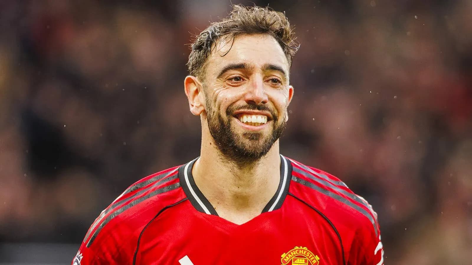 Player in red jersey smiling during match Player in red jersey smiling during match