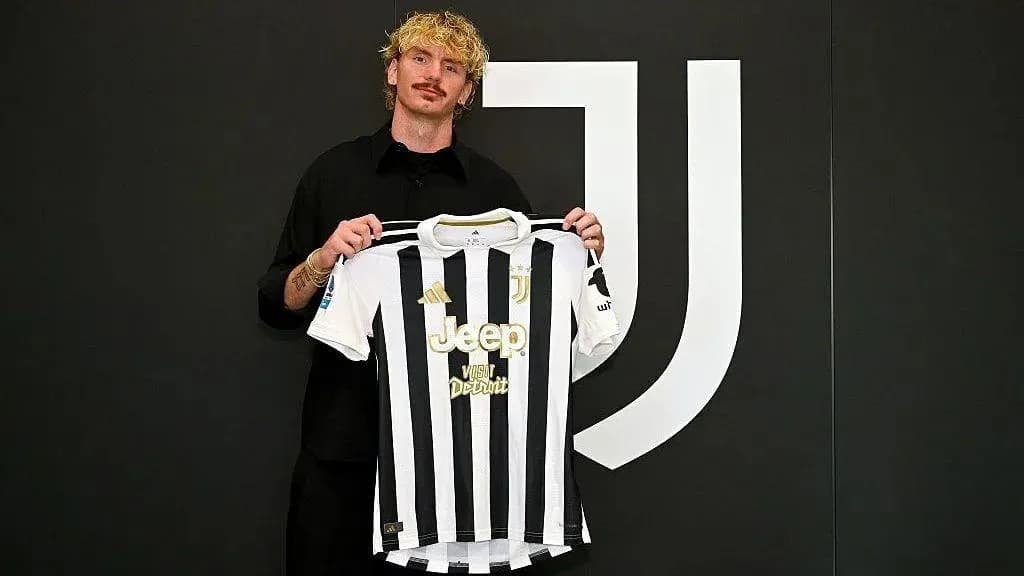 Player holding Juventus jersey during presentation event Player holding Juventus jersey during presentation event