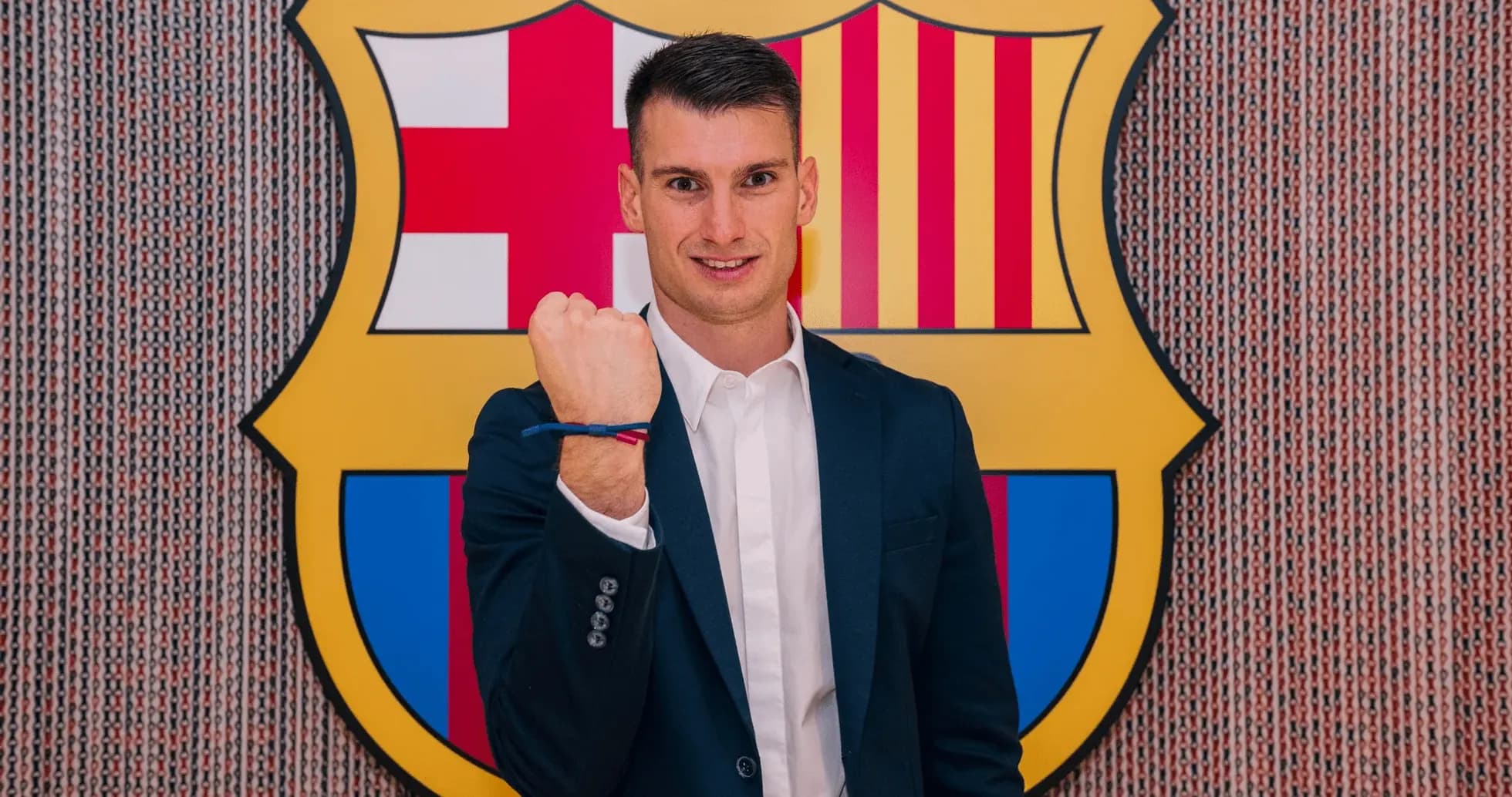 Player posing with fist raised at Barcelona logo Player posing with fist raised at Barcelona logo