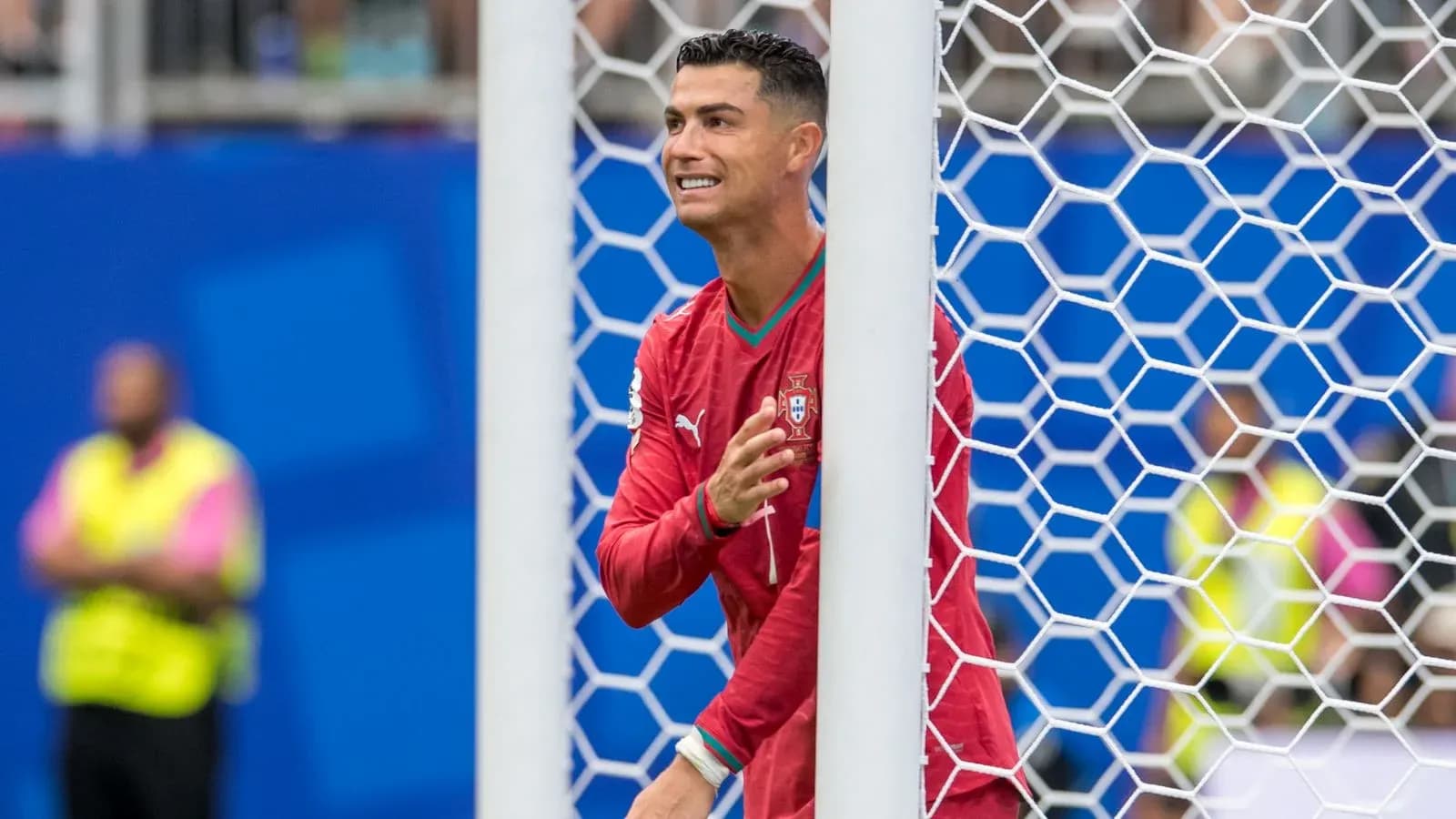 Cristiano Ronaldo gesturing from behind goal post Cristiano Ronaldo gesturing from behind goal post