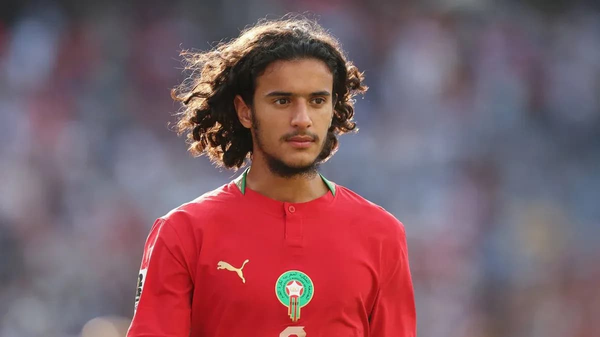 Player wearing red Morocco jersey on the field Player wearing red Morocco jersey on the field