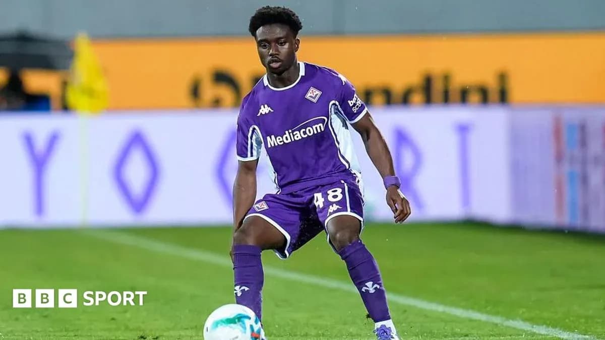 Player in purple kit preparing to receive ball Player in purple kit preparing to receive ball