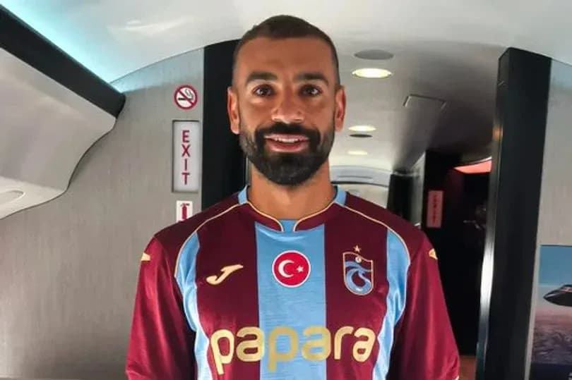 Player wearing Trabzonspor jersey in airplane cabin Player wearing Trabzonspor jersey in airplane cabin