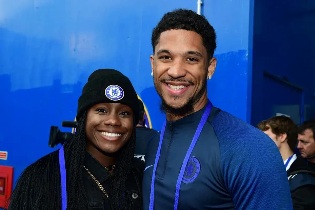 Two individuals posing in Chelsea FC attire Two individuals posing in Chelsea FC attire