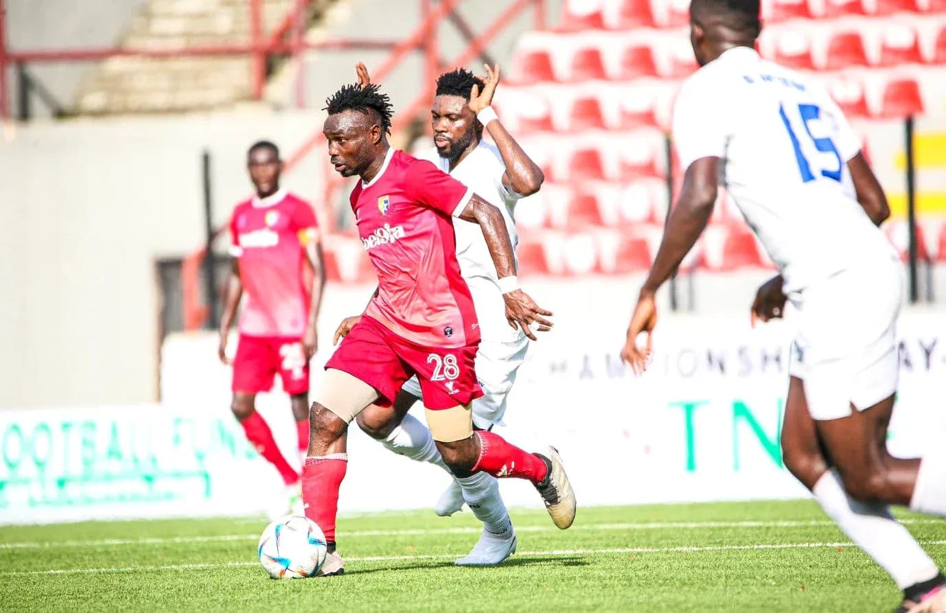 Katsina United player dribbling past opponent Katsina United player dribbling past opponent