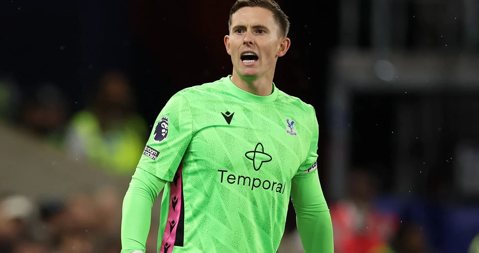 Goalkeeper in green kit shouting on the field Goalkeeper in green kit shouting on the field
