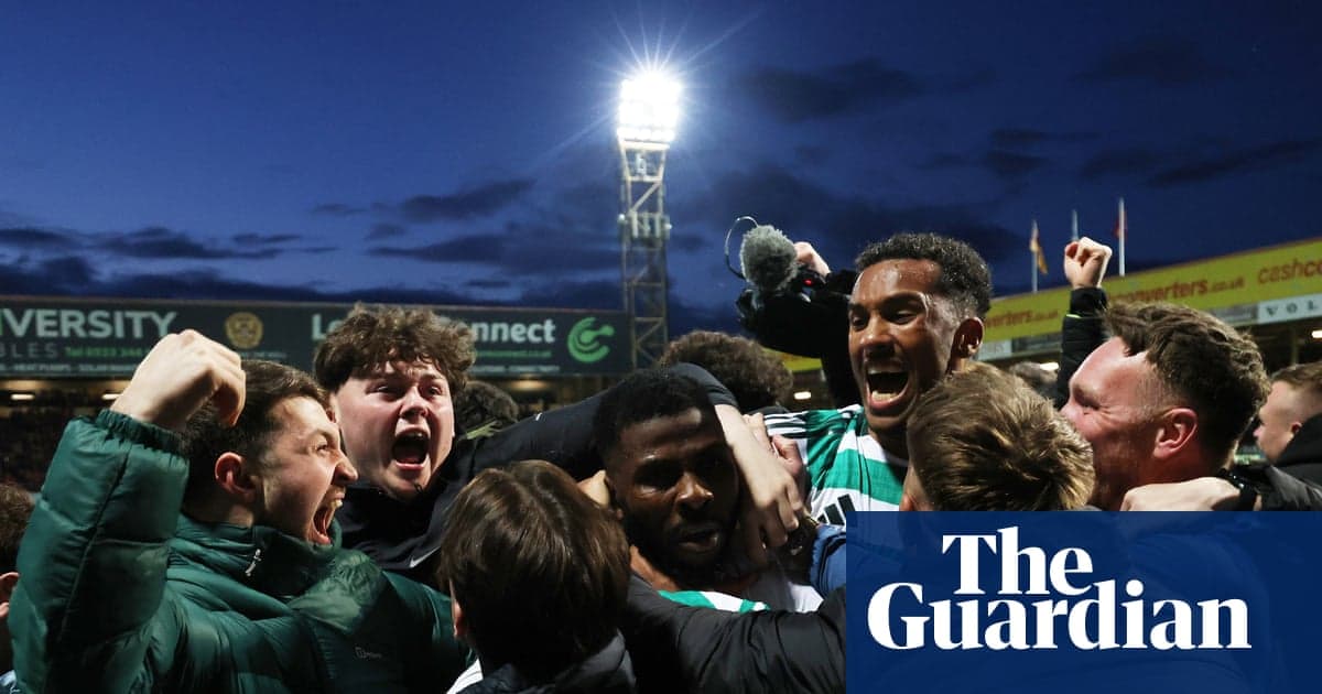 Fans celebrating a goal during a football match Fans celebrating a goal during a football match