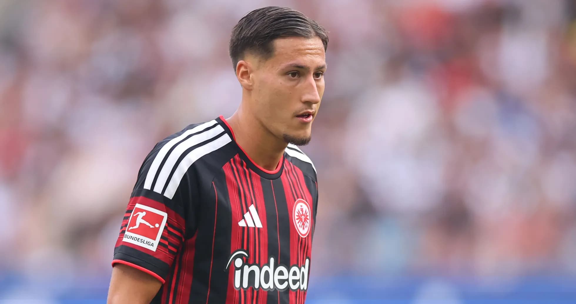 Player in Eintracht Frankfurt jersey on the field Player in Eintracht Frankfurt jersey on the field
