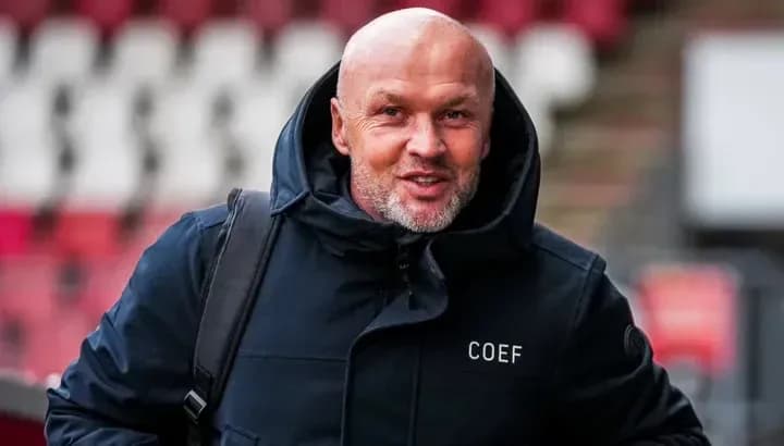 Man in black coat smiling at camera Man in black coat smiling at camera