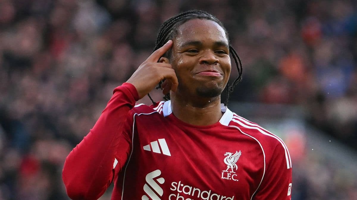Player celebrating with a hand gesture on pitch Player celebrating with a hand gesture on pitch