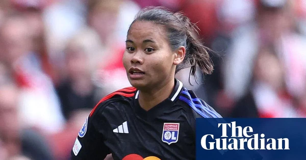 Player in action wearing Lyon jersey on field Player in action wearing Lyon jersey on field
