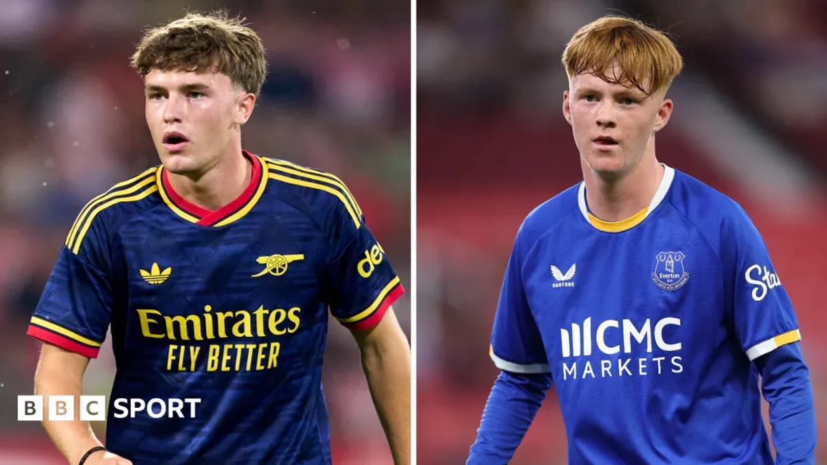 Two football players in club kits during match Two football players in club kits during match