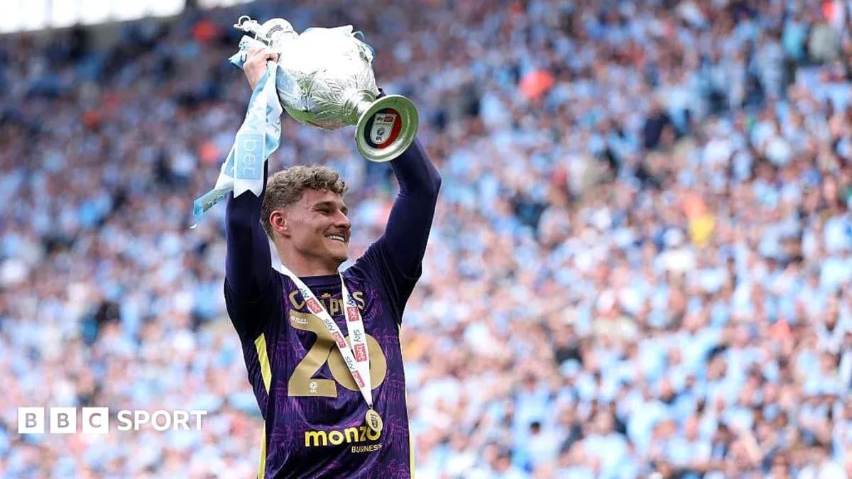 Goalkeeper lifting trophy in celebration after match Goalkeeper lifting trophy in celebration after match