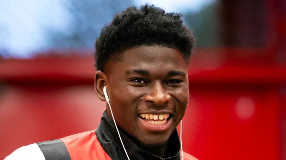 Player smiling while wearing headphones in training gear Player smiling while wearing headphones in training gear