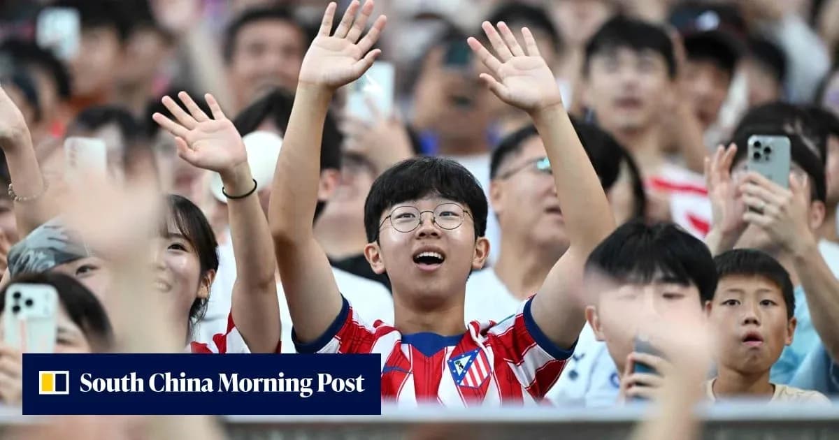 Young fan cheering in Atlético Madrid jersey Young fan cheering in Atlético Madrid jersey
