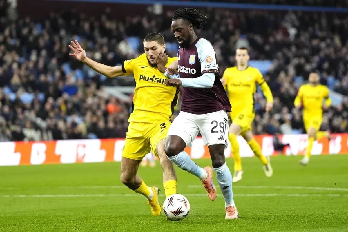 Player dribbling ball while being challenged by opponent Player dribbling ball while being challenged by opponent