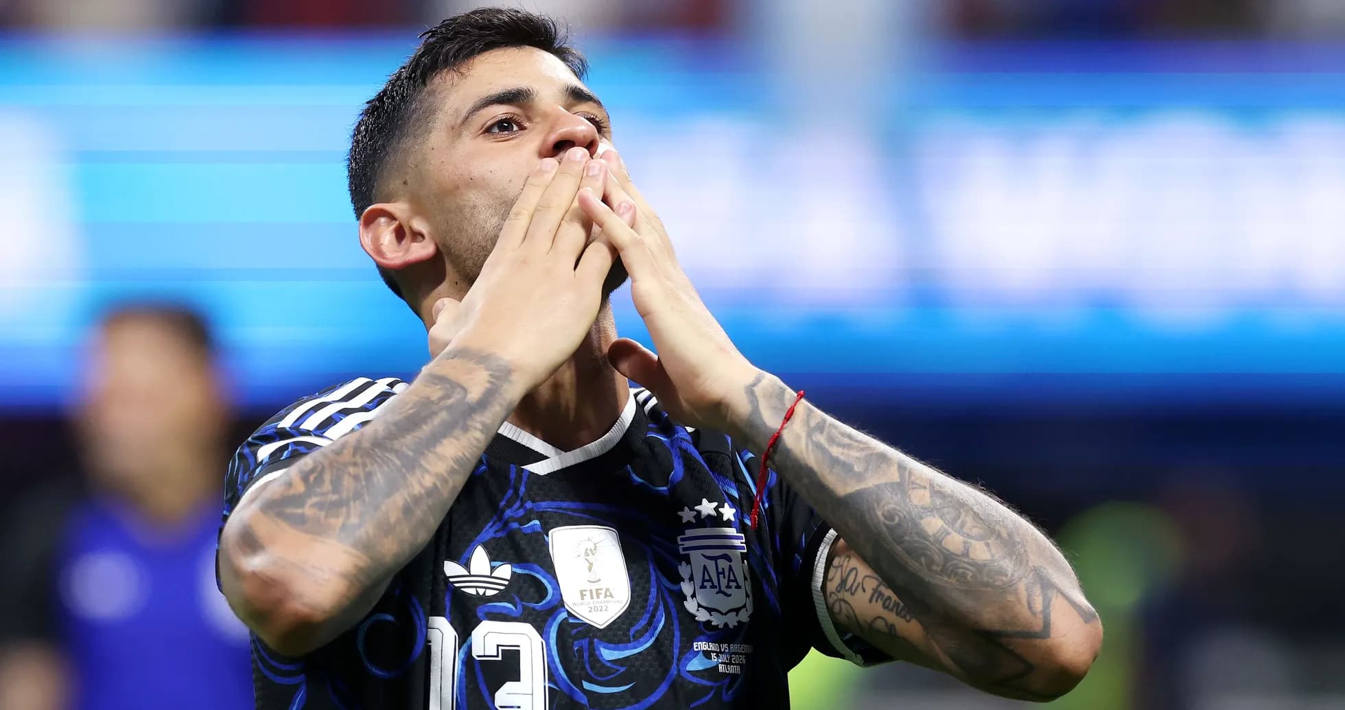 Player celebrating after a match, wearing Argentina jersey Player celebrating after a match, wearing Argentina jersey