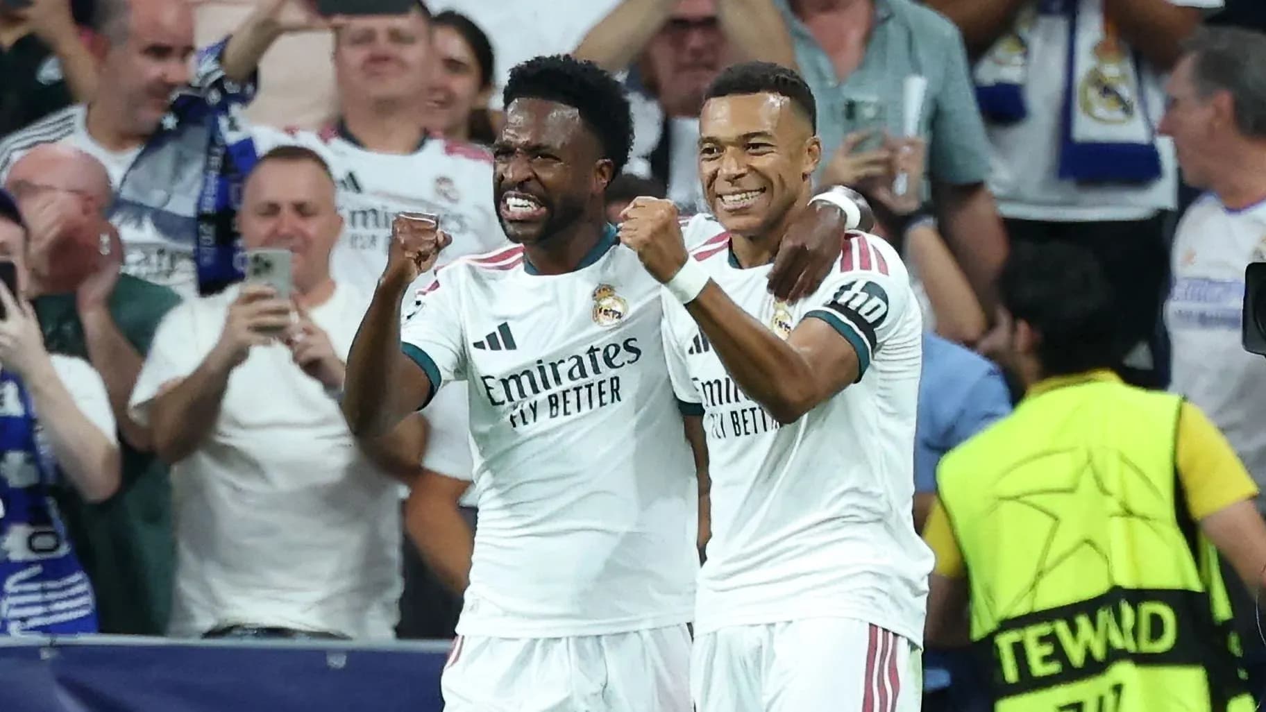 Two Real Madrid players celebrating a goal together Two Real Madrid players celebrating a goal together